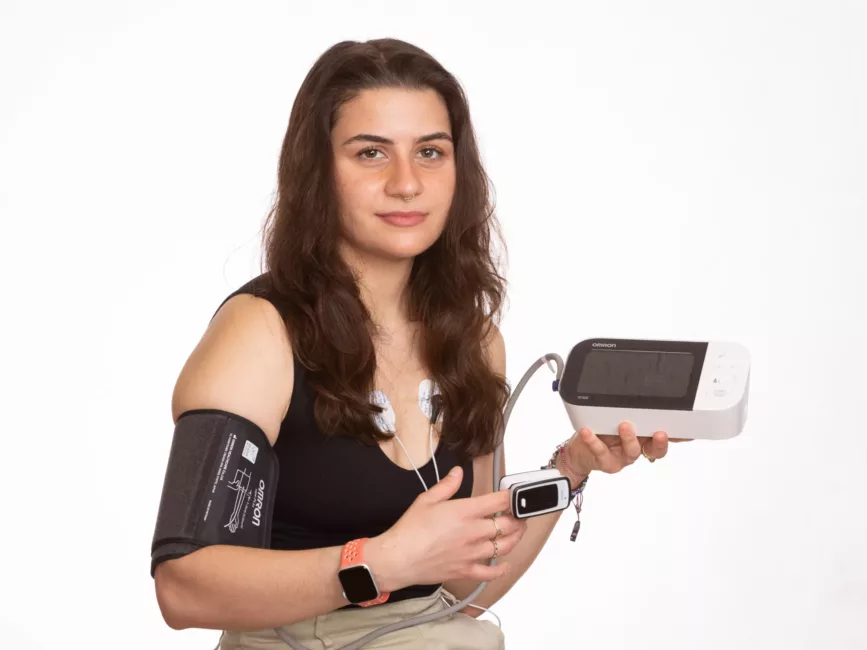 Women wearing a pulse oximeter and a blood pressure cuff